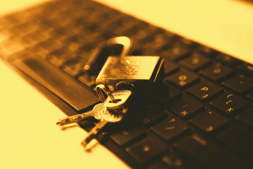 Database locks are represented by keys unlocking a padlock with a computer in the background